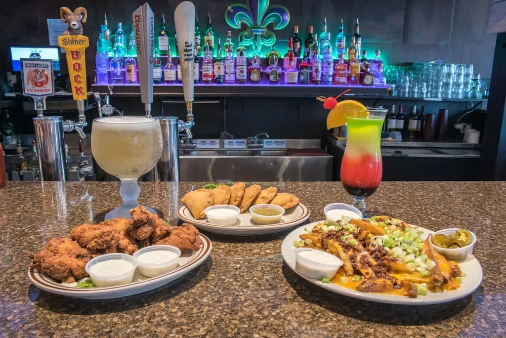 Bar counter with various food, drinks, and a liquor display.