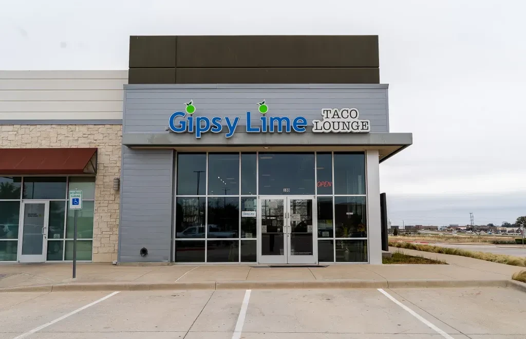 Modern Gipsy Lime Taco Lounge storefront with large glass windows.