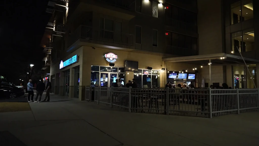 Woodrow's Drafthouse & Eatery exterior at night, with a lit patio.
