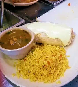 Cheesy burrito, yellow rice, and bean soup on a plate.