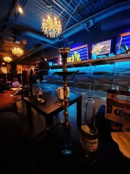 Ornate hookah, two Corona beers in a dim, blue-lit lounge.