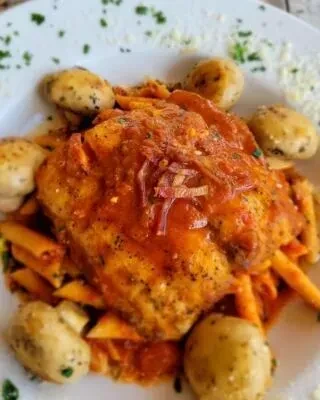 Hearty protein in tomato sauce with mushrooms, penne, and cheese.