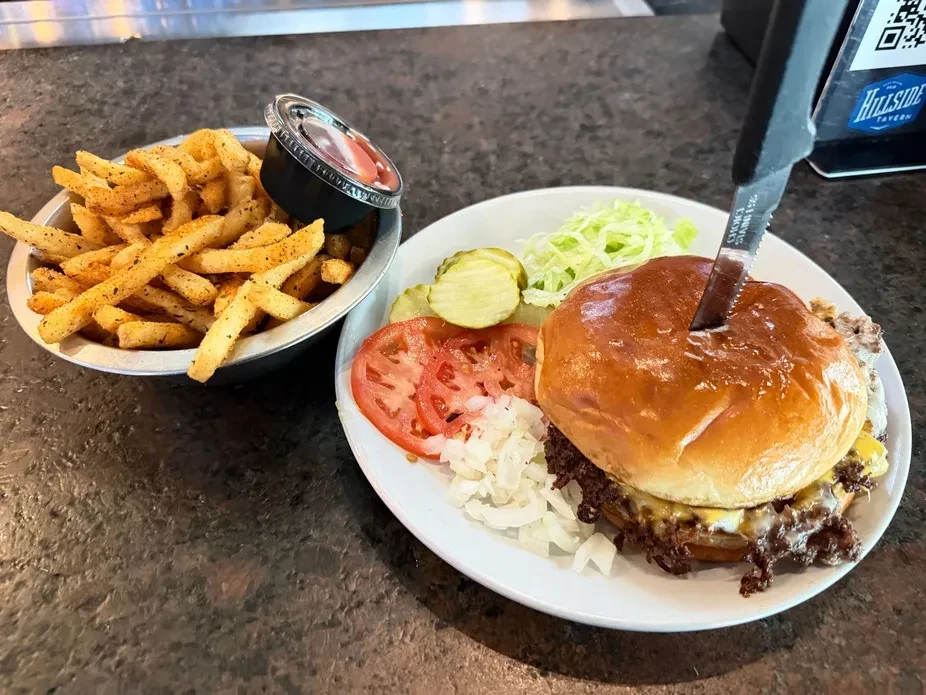 Overhead view of burger, fries, and sauce at Hillside Tavern.