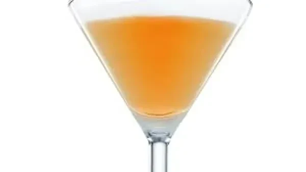 Amber cocktail in a classic martini glass.