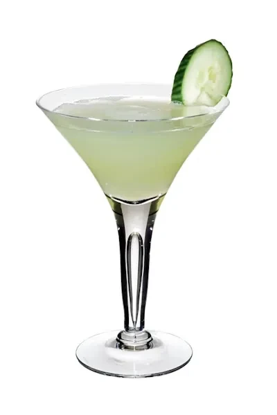 Pale green cocktail in martini glass with cucumber garnish.