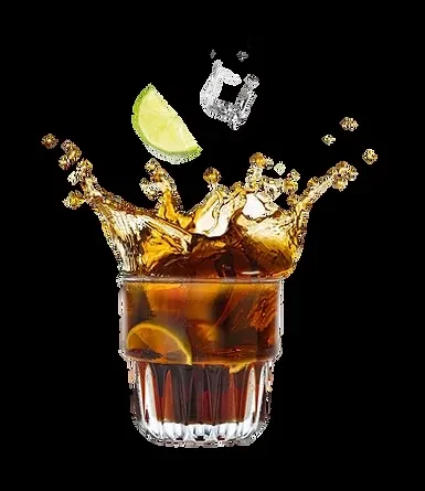Dark drink splashing from a ribbed glass with lime and ice.