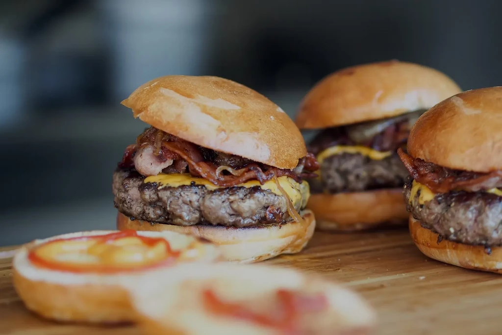 Thick bacon cheeseburger with melted cheese, bacon, and caramelized onions.