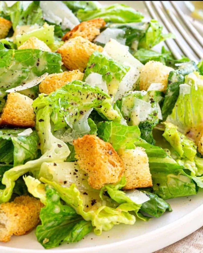 Caesar salad with romaine, croutons, Parmesan, black pepper, and creamy dressing.