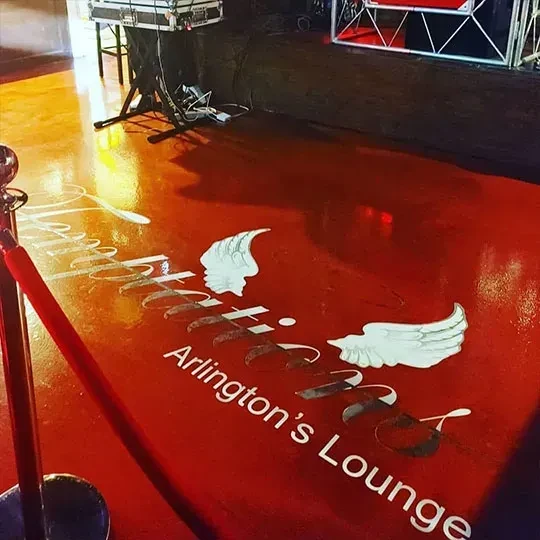Reflective red club floor with "Arlington's Lounge" and winged logo.