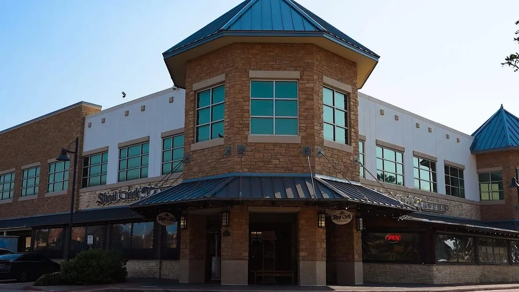 Shoal Creek Tavern, multi-story building with an octagonal blue turret.