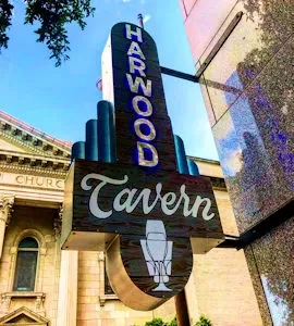 Vintage HARWOOD Tavern sign with stacked text and a beer glass.