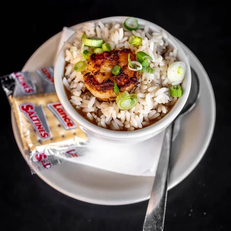 Seared seafood and rice stew with green onions and Lance Saltines.
