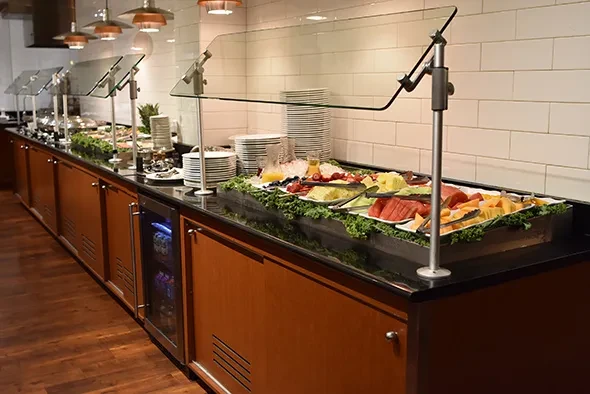 Well-stocked breakfast buffet with fresh fruit, juices, and hot dishes.