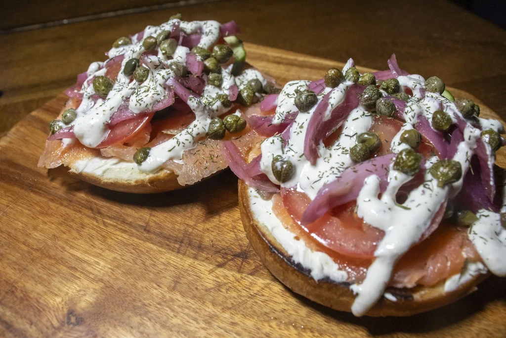 Bagel halves topped with smoked salmon, cream cheese, onions, capers, dill.