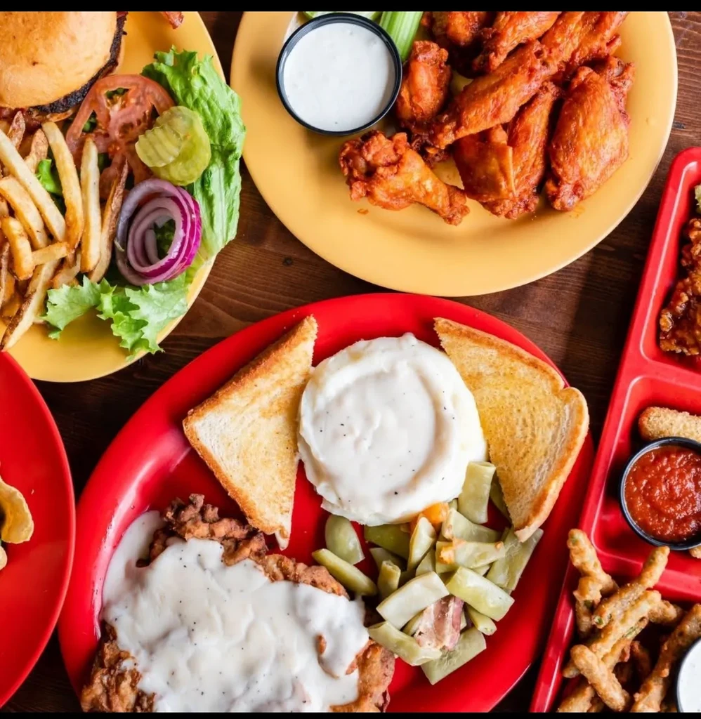 Overhead view of a burger, chicken wings, and chicken fried steak.