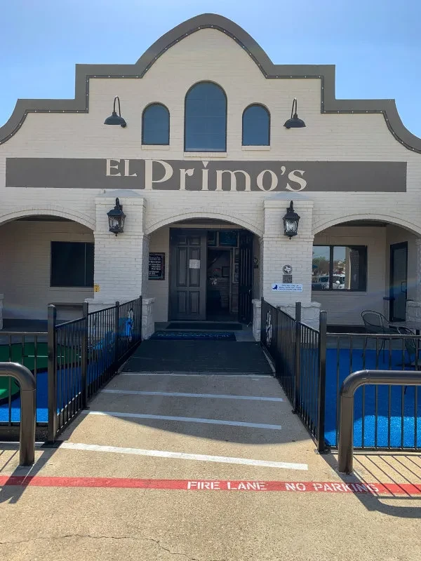 EL Primo's brick building with arched roof, mini-golf, and fire lane.