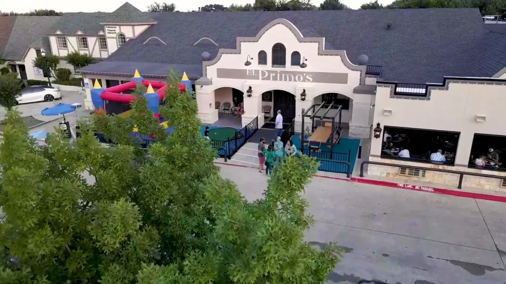 El Primo's restaurant exterior with arched entry, mini-golf, and bouncy house.