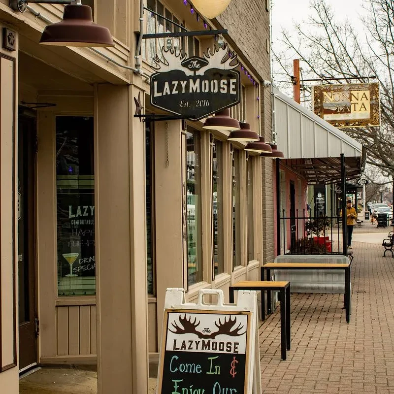 The Lazy Moose restaurant exterior with prominent sign on a city street.