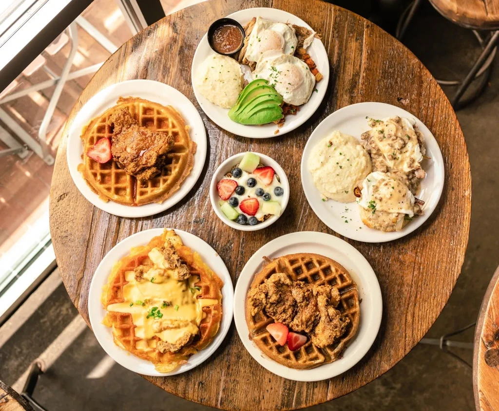 Overhead view of a rustic table with many breakfast and brunch dishes.
