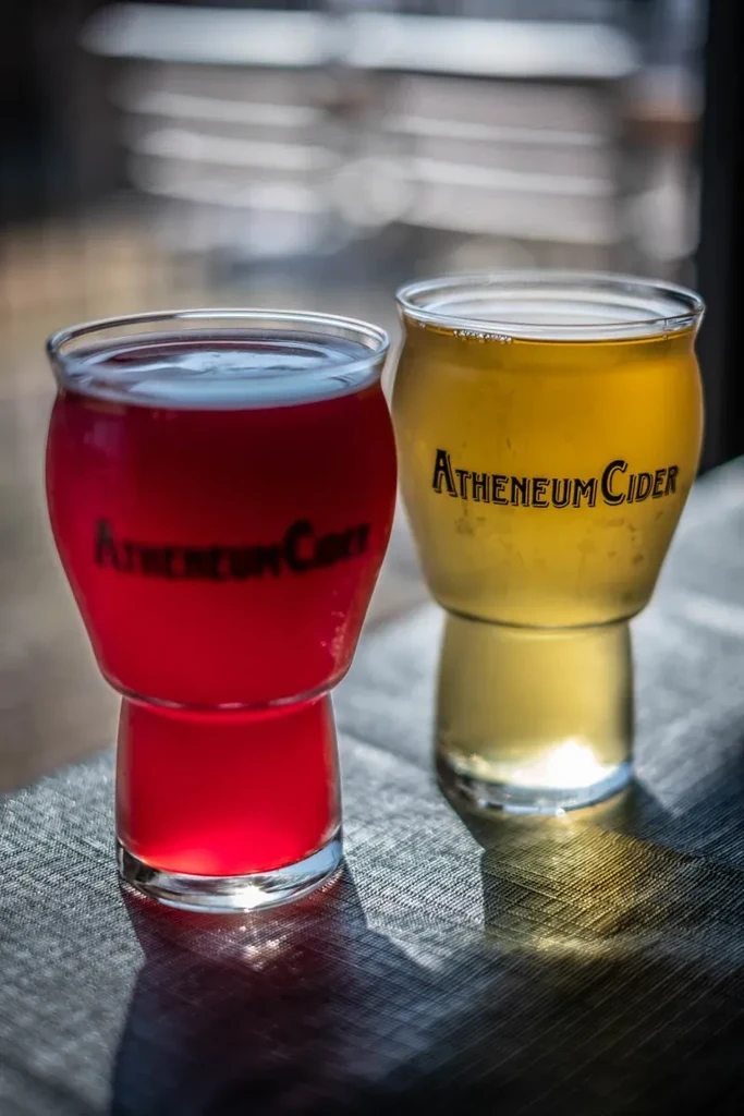 Two Atheneum Cider tumblers, pink and amber, side-by-side.