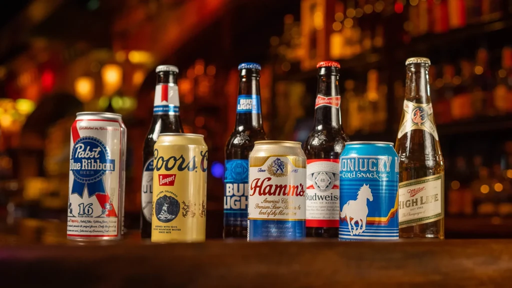 Various beer cans and bottles on a wooden bar counter.