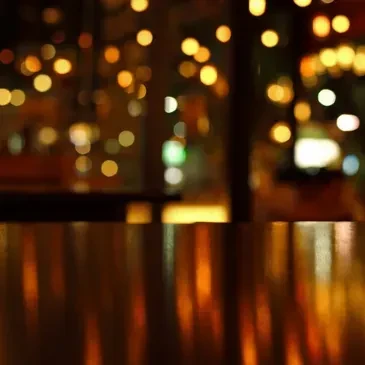 Softly lit interior with warm bokeh circles and surface reflections.