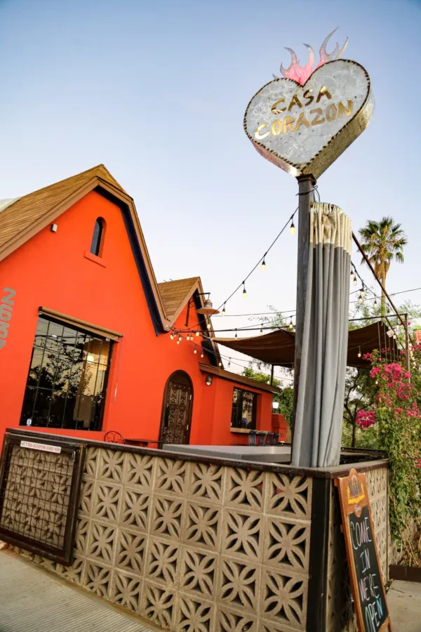 Exterior of bright orange Casa Corazon restaurant with heart sign.