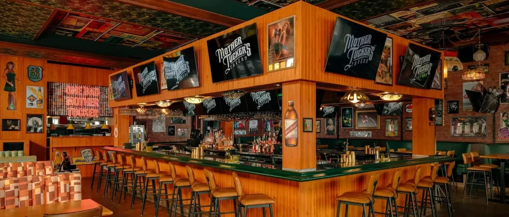 Retro Mother Tucker's Tavern interior with wood walls and eclectic decor.