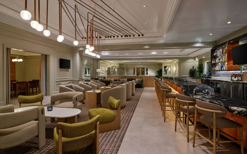 Modern, elegant lounge and bar with copper bar front and unique lighting.