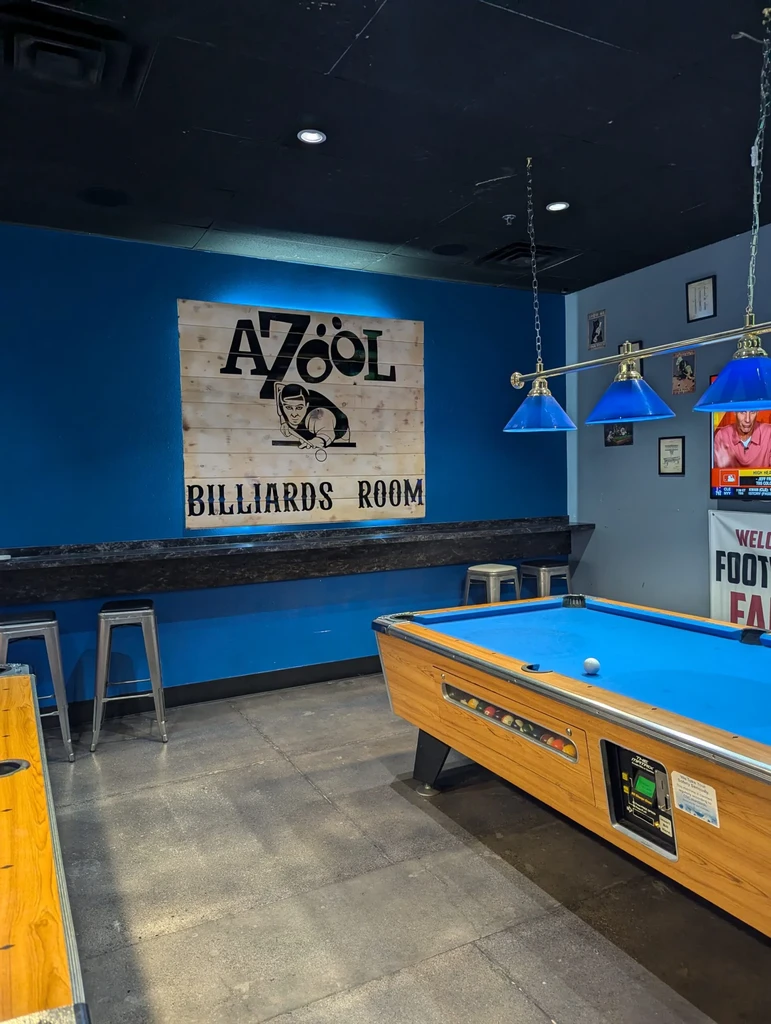 Azool Billiards Room with a blue pool table, shuffleboard, and TV.
