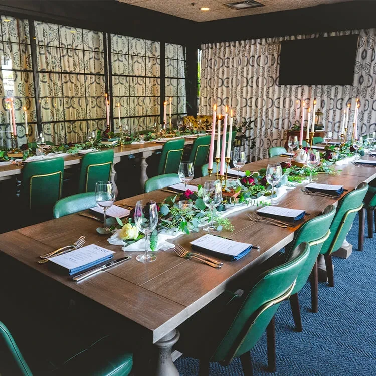 Formal dining table with flowers, candles, and place settings.