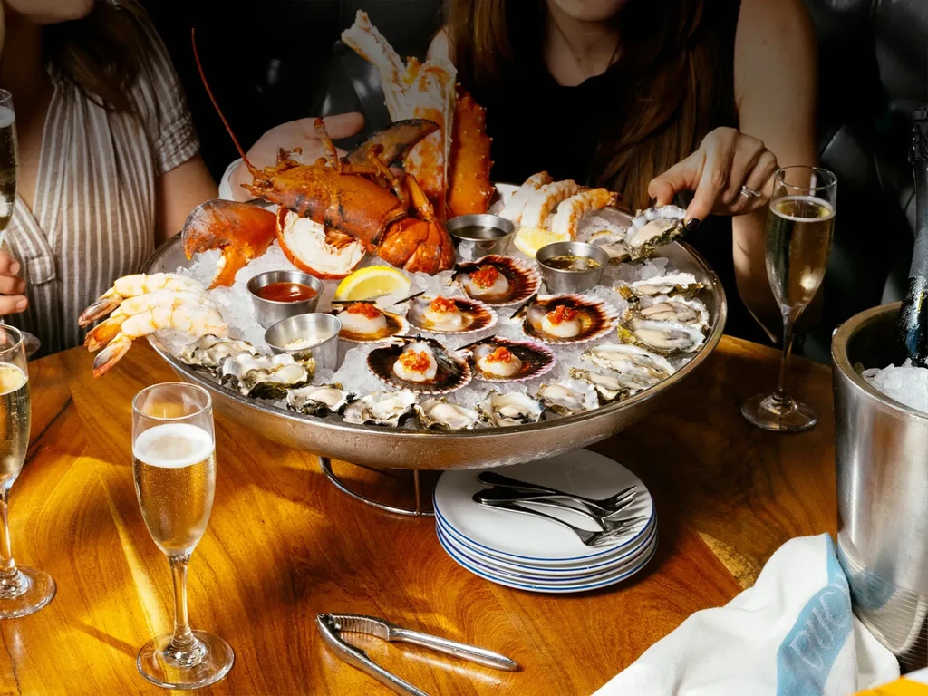 An elaborate seafood platter featuring lobster, shrimp, oysters, and scallops.