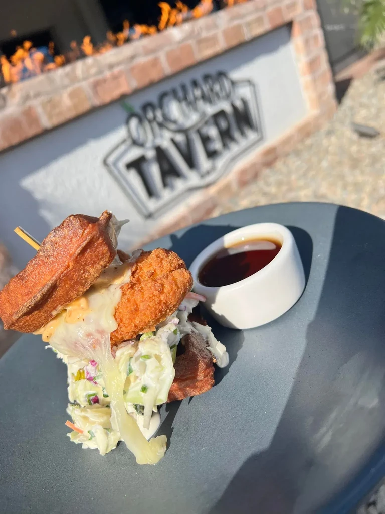 Chicken and waffle sandwich with coleslaw served at Orchard Tavern.