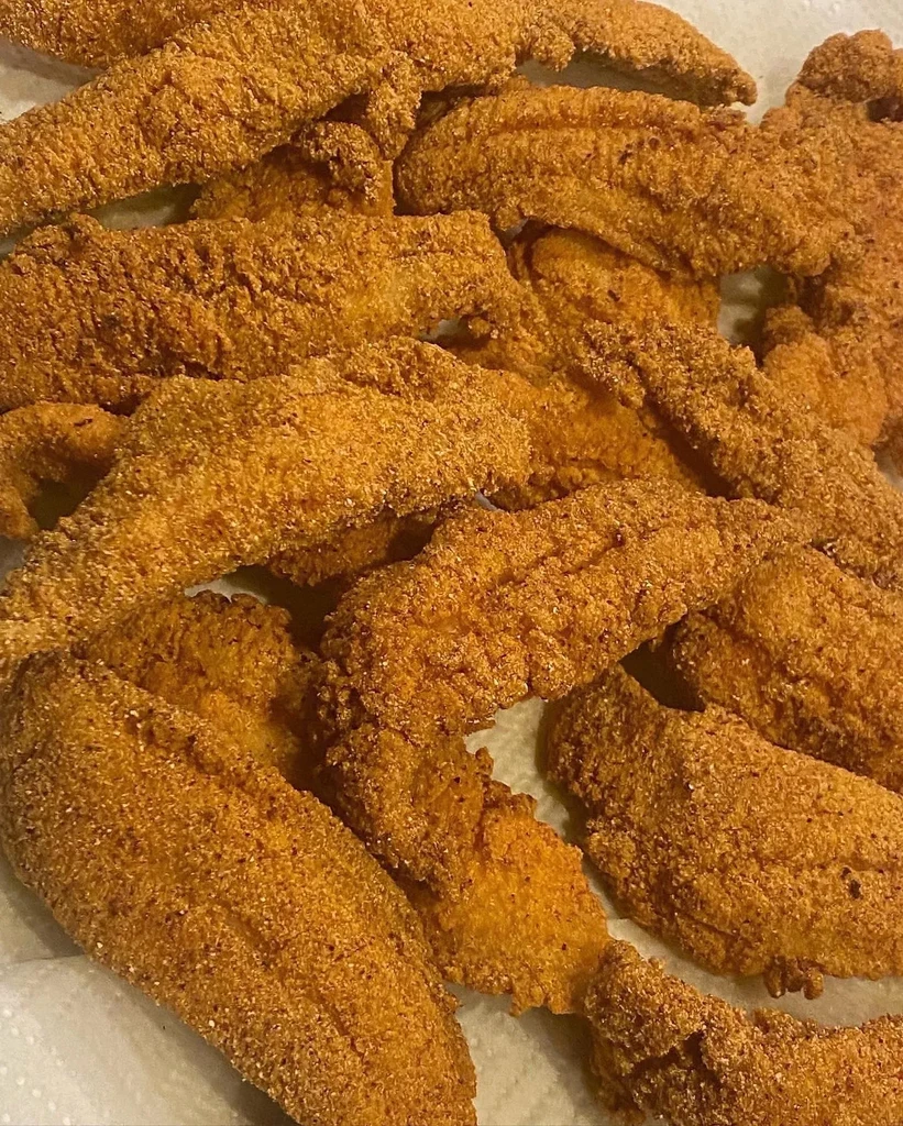 Multiple golden-brown, crispy fried fish or chicken pieces.