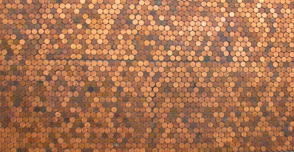Wall or floor densely covered in varied copper pennies.