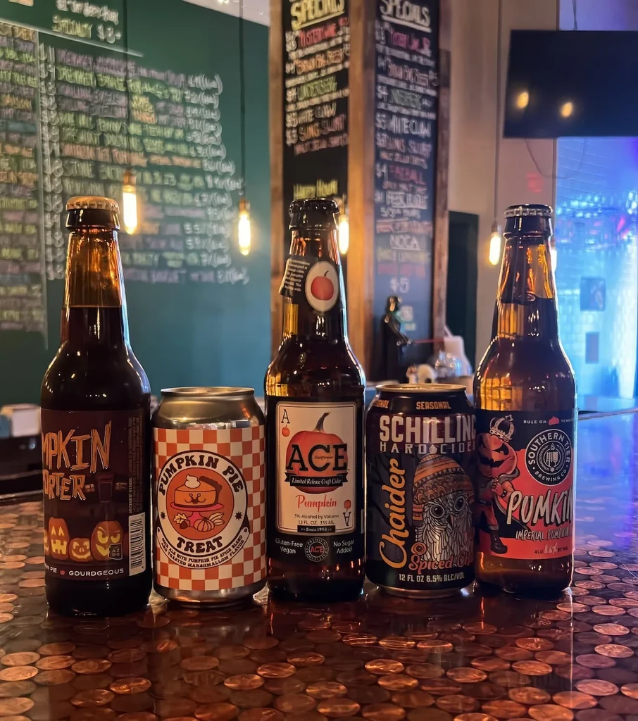 Five pumpkin beverages on a copper penny bar counter.