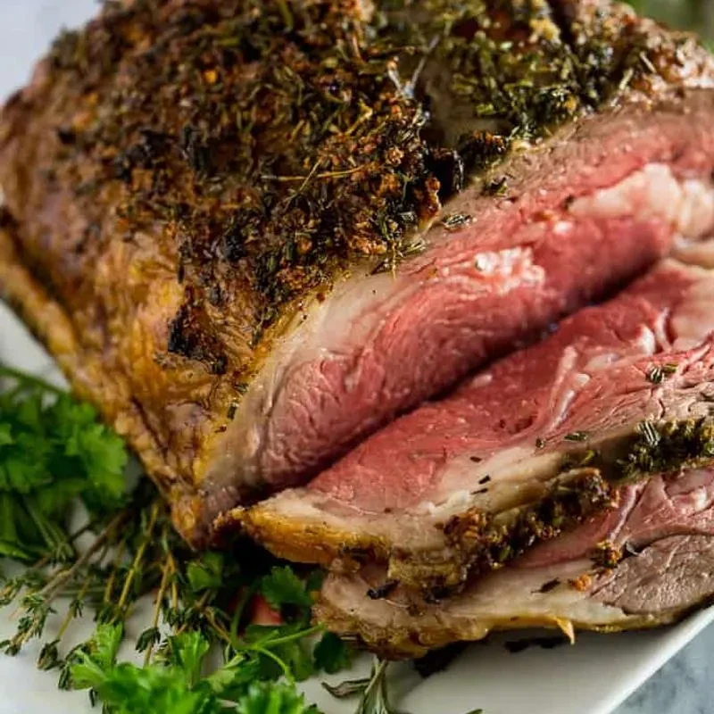 Sliced medium-rare prime rib with a crispy herb crust.