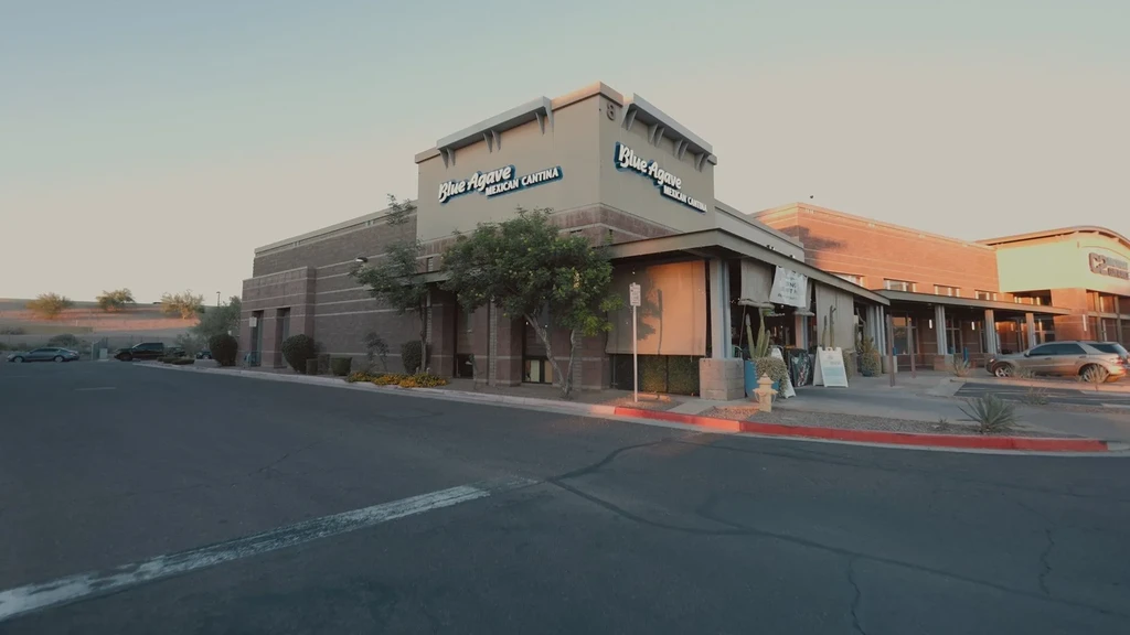 Exterior view of Blue Agave Mexican Cantina in a desert commercial strip.