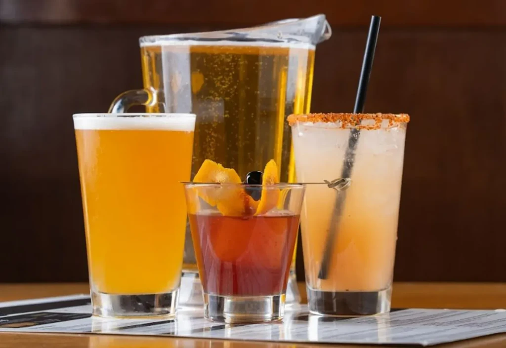 Table displays a beer pint, cocktail, beer pitcher, and a spiced drink.