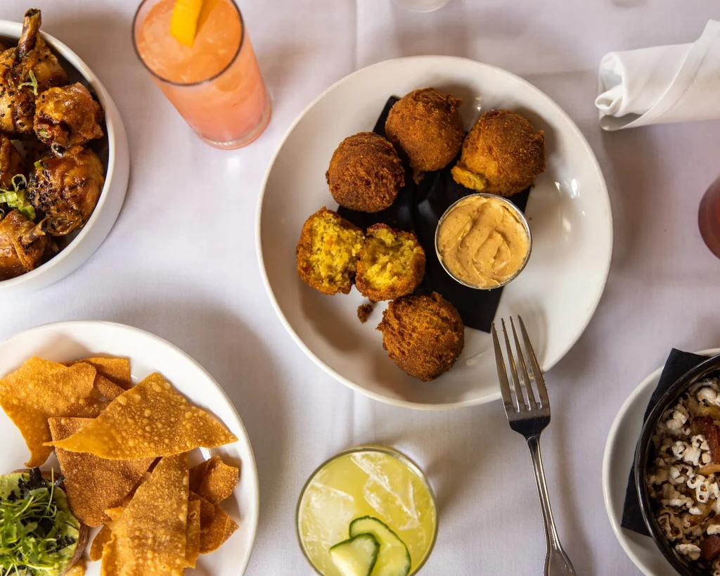 Overhead view of a dining table laden with diverse food and drinks.