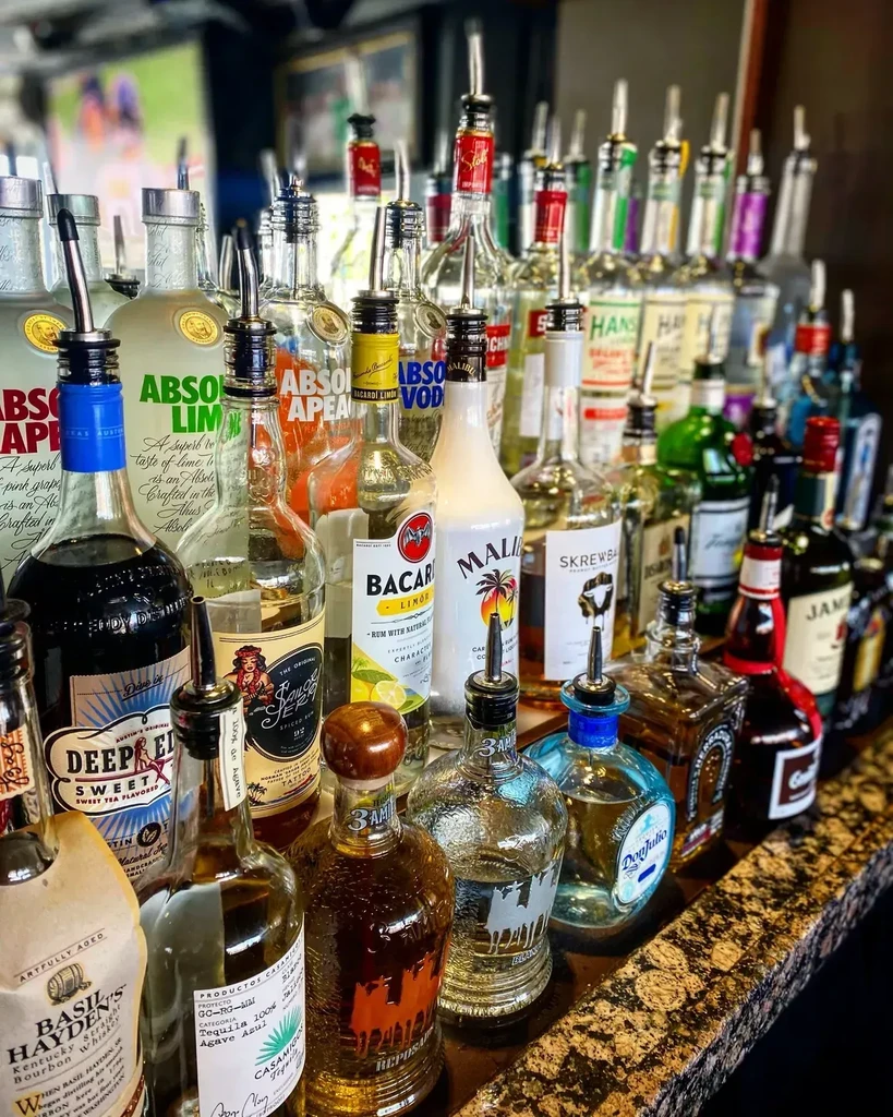 Well-stocked bar counter filled with a variety of spirits.