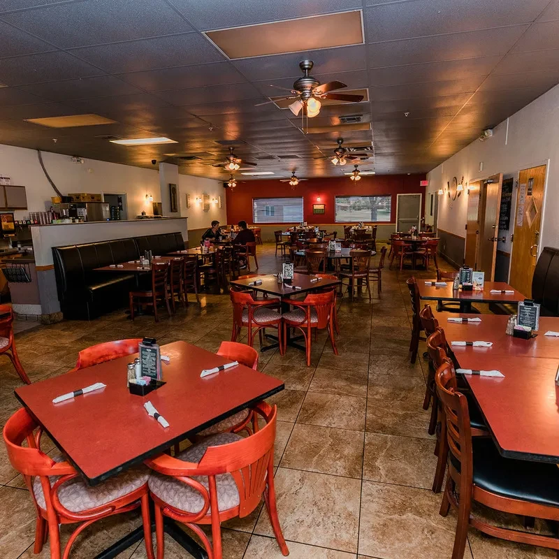Clean, well-lit casual dining restaurant interior with tables and patrons.