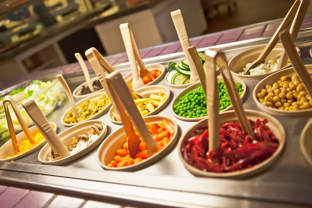 A vibrant, well-organized self-service salad bar with fresh ingredients.