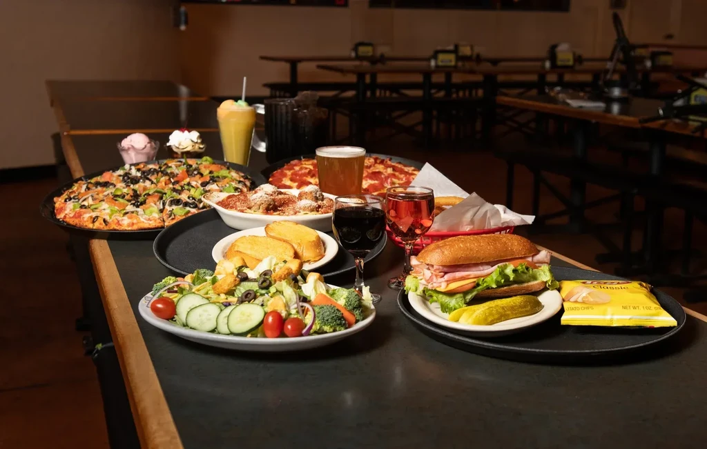 Bountiful spread of diverse food and drinks on a restaurant table.