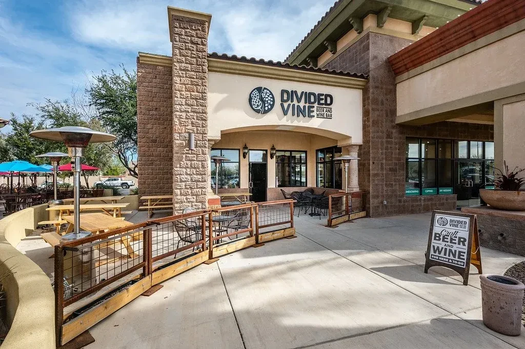Divided Vine Beer and Wine Bar exterior with outdoor patio seating.