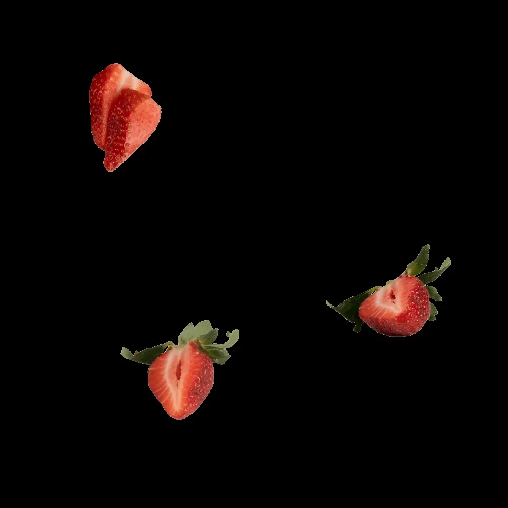 Three vibrant red strawberry slices with green tops on black.