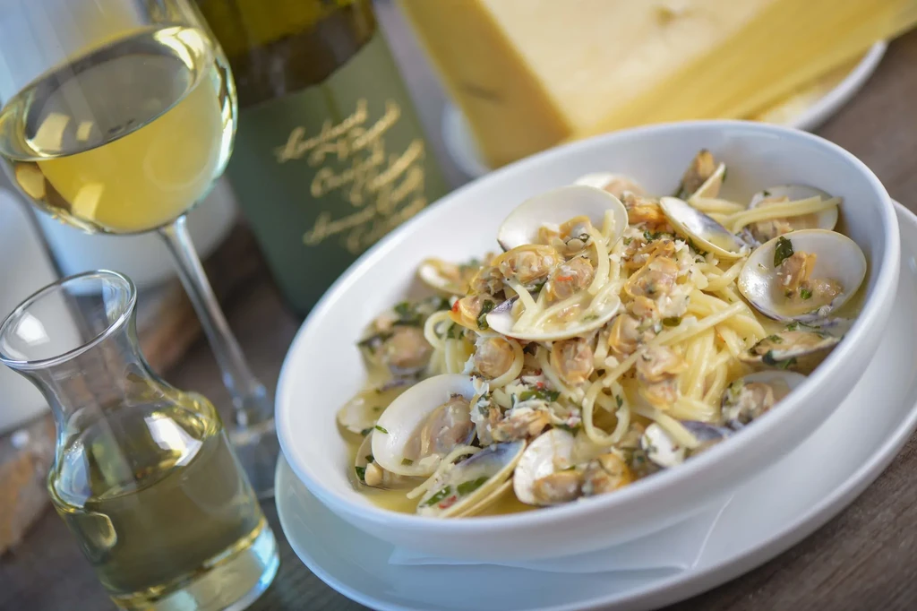 Close-up: spaghetti vongole, white wine, olive oil, and cheese.