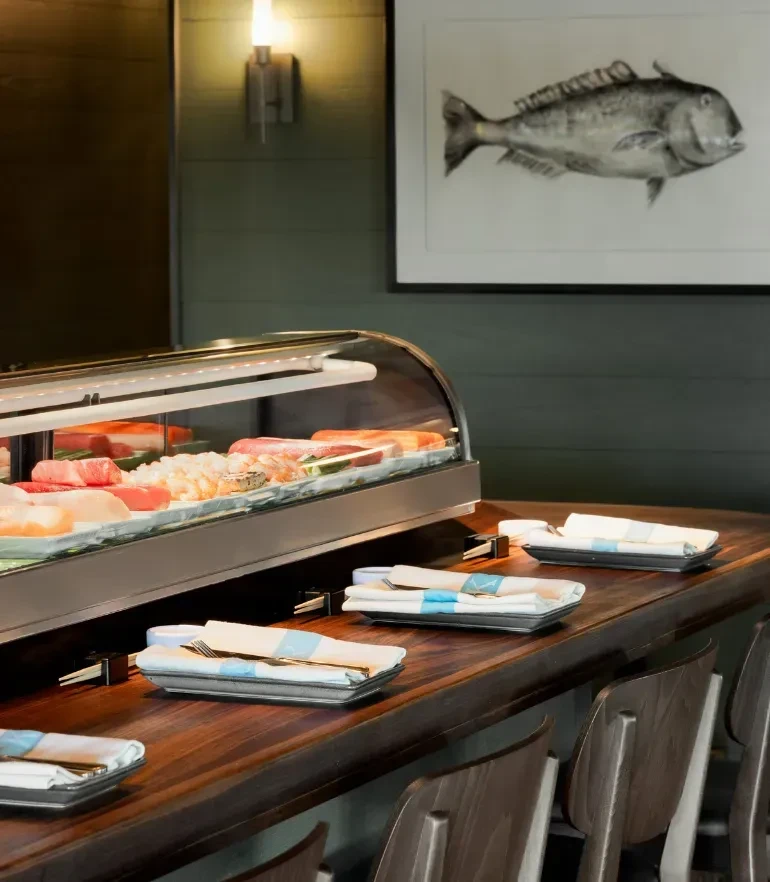 Refrigerated display case with fresh tuna, salmon, and shrimp.