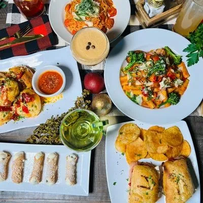 Flat lay of a table filled with diverse Italian food and drinks.