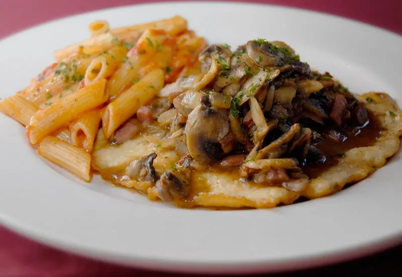 Penne pasta with tomato cream sauce, cutlet with mushroom sauce.